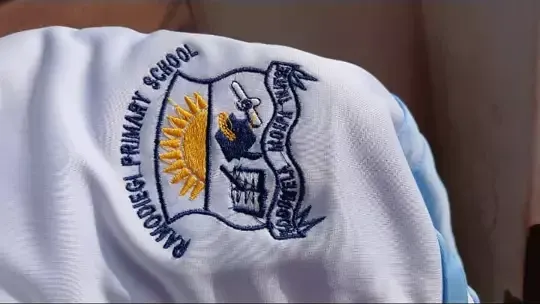 Ramodiegi Primary School crest embroidered on white fabric