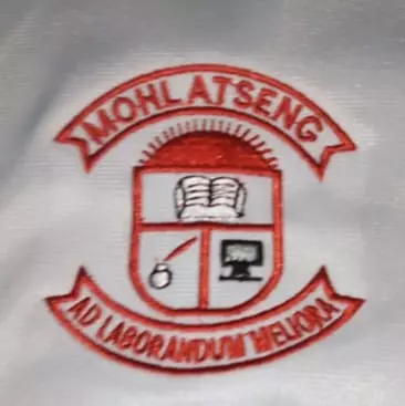 School crest embroidered on white fabric